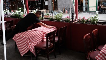 A member of the staff prepares a table at a restaurant in Manhattan on August 31, 2020 in New York City.