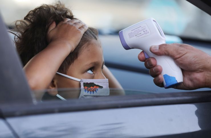 A student receives a temperature check before leaving the car to enter a tutoring center on Sept. 2 in Culver City, California.