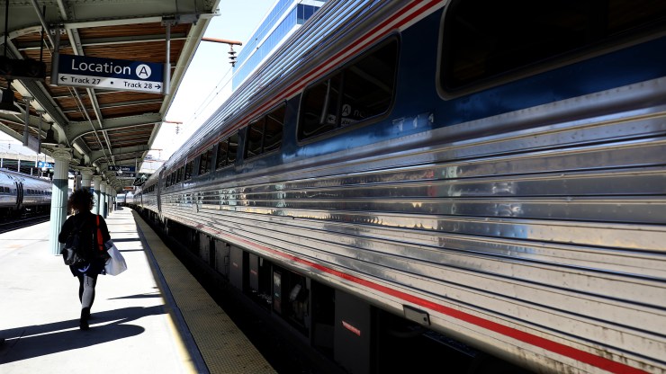 A passenger walks to a departing Amtrak train at Union Station in April in Washington, D.C.