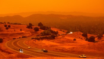 Cars drive below an orange sky filled with wildfire smoke in Concord, California, on Sept. 9.