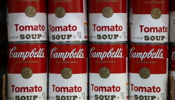 Cans of Campbell's tomato soup for sale at a grocery store.