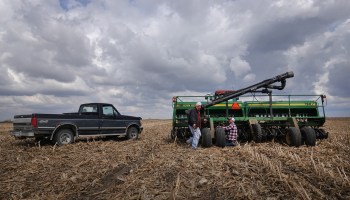 Farmers repair a grain drill while planting soybeans in April in Illinois.