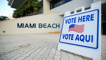 A sign directs voters to a polling location during the Florida presidential primary in March at Miami Beach City Hall.