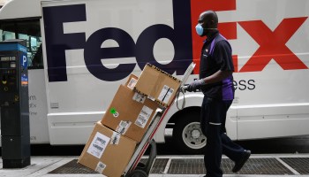 A FedEx driver wearing a mask makes deliveries in Manhattan on Sept. 17 in New York City.