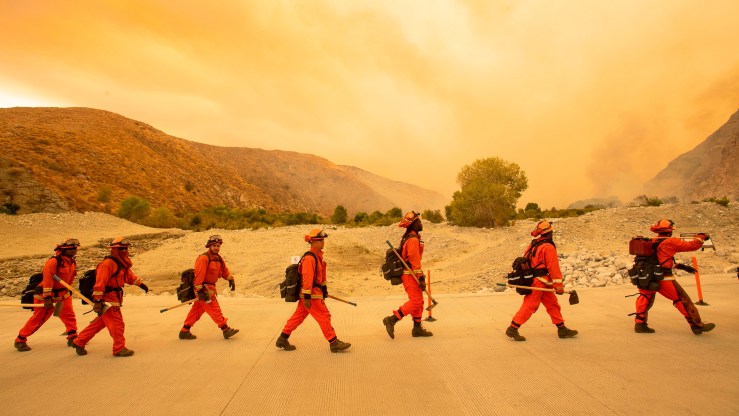 Inmate firefighters arrive at the scene of a fire in Whitewater, California, in August.
