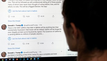 A person looking at tweets from the account of President Trump flagged by Twitter.