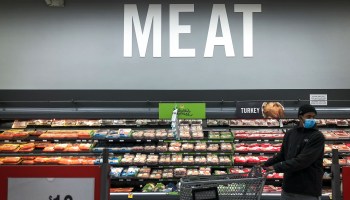 A man wearing a face mask shops in the meat section of a Washington, D.C., grocery store in April.