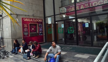 People sit outside the closed Hidalgo Theater in Mexico City in March.