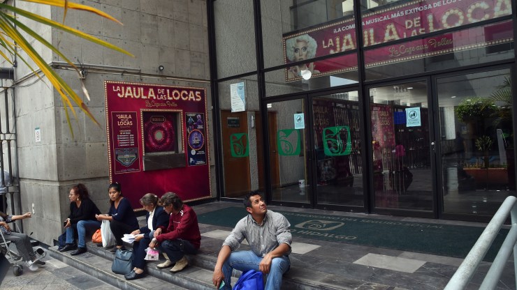 People sit outside the closed Hidalgo Theater in Mexico City in March.