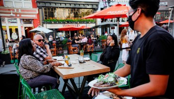 Patrons dine at an outdoor restaurant in downtown San Diego, California, in July.