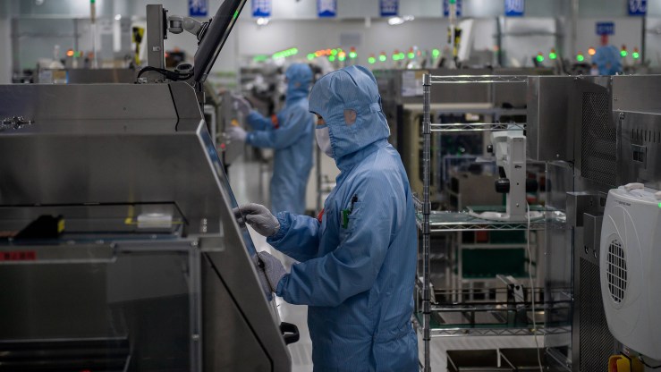 Workers build semiconductors at a factory in Beijing.
