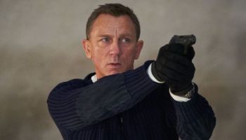 Actor Daniel Craig, playing James Bond, holds a gun in a scene from the forthcoming "No Time to Die."