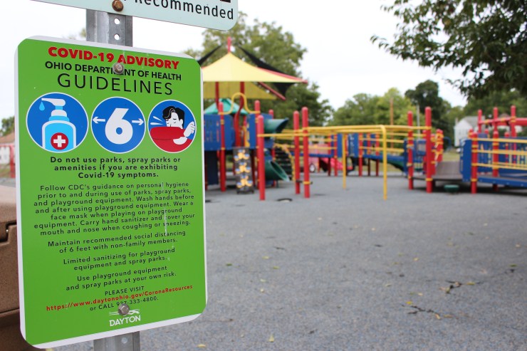 COVID-19 safety guidelines are posted at McIntosh Park in Dayton, Ohio.