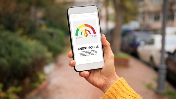 A smartphone displays a credit score chart.