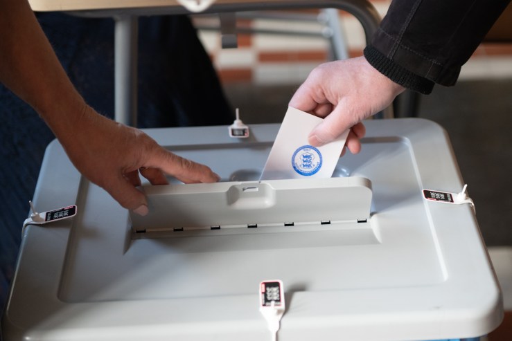 A ballot is cast in a voting box during Estonia's general election in a voting station in Tallin, on March 3, 2019.