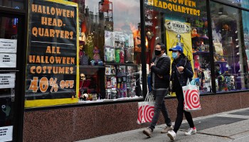 People walk by a store selling Halloween costumes on October 25, 2020 in New York City.