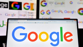 A picture taken on Nov. 20, 2017 shows logos of multinational technology company Google displayed on computers' screens.