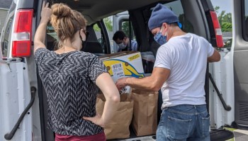 A team from the Landing Place, an organization for at-risk youth, prepares bags of food and other supplies for families in Maine's midcoast region.