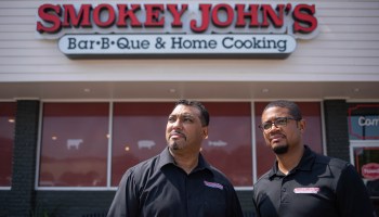 Brothers Juan (left) and Brent Reaves stand in front of their store, Smokey John’s Bar-B-Que in Dallas.