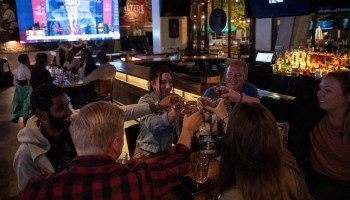 A group of people takes shots before they watch the first presidential debate at a sports bar on Sept. 29 in Washington, D.C.