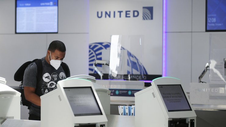 A passenger checks in for a United Airlines flight at Los Angeles International Airport on Oct. 1.