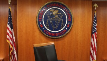 The seal of the Federal Communications Commission hangs behind commissioner Tom Wheeler's chair inside the hearing room at the FCC headquarters February 26, 2015 in Washington, DC.