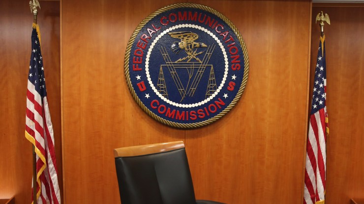 The seal of the Federal Communications Commission hangs behind commissioner Tom Wheeler's chair inside the hearing room at the FCC headquarters February 26, 2015 in Washington, DC.