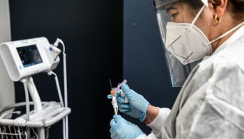 A nurse holds a COVID-19 vaccine at the Research Centers of America in Hollywood, Florida.n August 13, 2020.