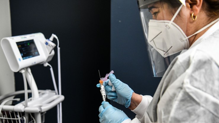 A nurse holds a COVID-19 vaccine at the Research Centers of America in Hollywood, Florida.n August 13, 2020.