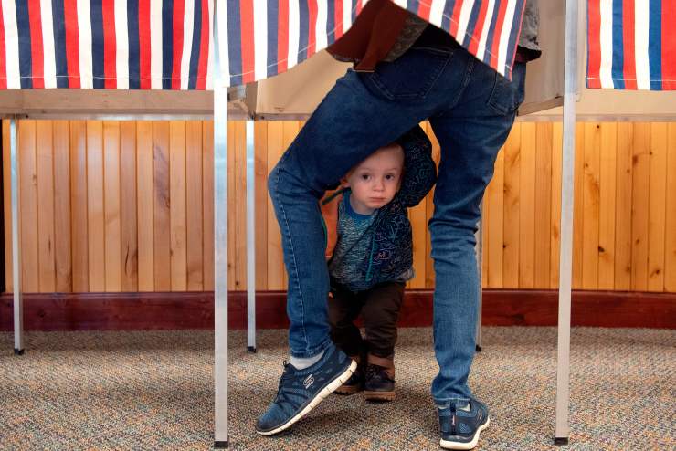 A child waits for his mother to cast her ballot in Colorado.