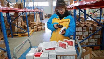 An employee checks items to be delivered to customers on Singles' Day, also known as the Double 11 shopping festival, at the warehouse of Suning Logistics Network in Shenyang, in northeastern China's Liaoning province on November 11, 2020.