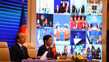 Vietnam's Prime Minister Nguyen Xuan Phuc (left) and Minister of Industry and Trade Tran Tuan Anh attend the signing ceremony for the Regional Comprehensive Economic Partnership (RCEP) trade pact at the ASEAN summit held online in Hanoi on November 15, 2020.