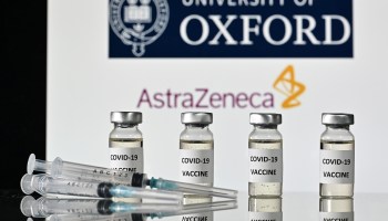 An illustration picture shows vials with COVID-19 Vaccine stickers attached and syringes, with the logo of the University of Oxford and its partner British pharmaceutical company AstraZeneca, on November 17, 2020.