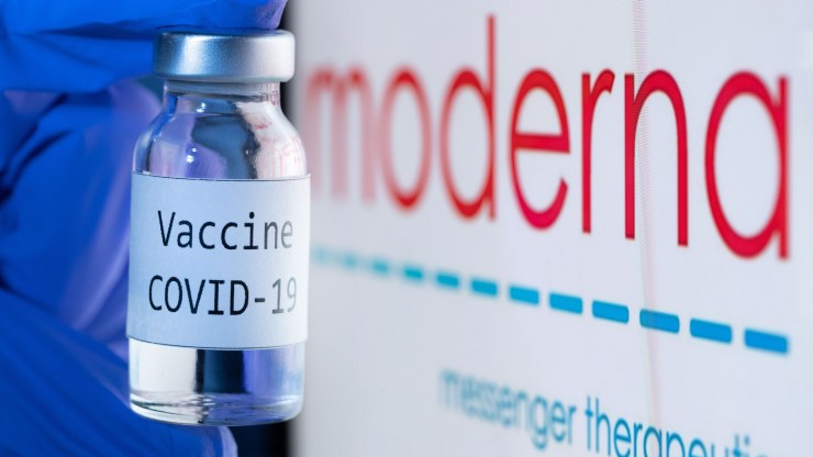 This picture taken on November 18, 2020 shows a bottle reading "Vaccine COVID-19" next to the Moderna biotech company logo.