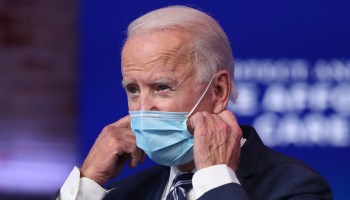 President-elect Joe Biden removes his mask before addressing the media about the Trump administration’s lawsuit to overturn the Affordable Care Act on November 10, 2020 at The Queen theater in Wilmington, Delaware.