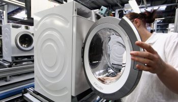 A worker assembles a washing machine at an appliance factory in Germany in February.