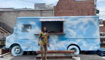 Terence Dickson stands in front of "Big Blue," a delivery truck he's converted into an outdoor bar at his restaurant in Baltimore.
