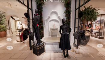 A screenshot of Ralph Lauren's Beverly Hills virtual storefront, showing the entranceway to the store. Christmas garlands surround a stone fountain, and a mannequin in an ornate jacket stands next to a saddle.