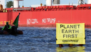 Greenpeace activists painted "No coal no Trump" on the side of a coal ship leaving Texas in 2017 after Trump said he would pull out of the Paris climate agreement.