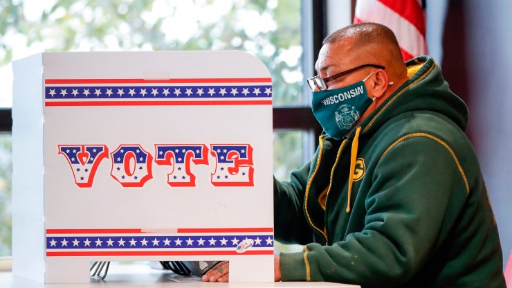 A man casts his ballot at Tippecanoe Library on the first day of in-person early voting in Milwaukee, Wisconsin, on Oct. 20, 2020.