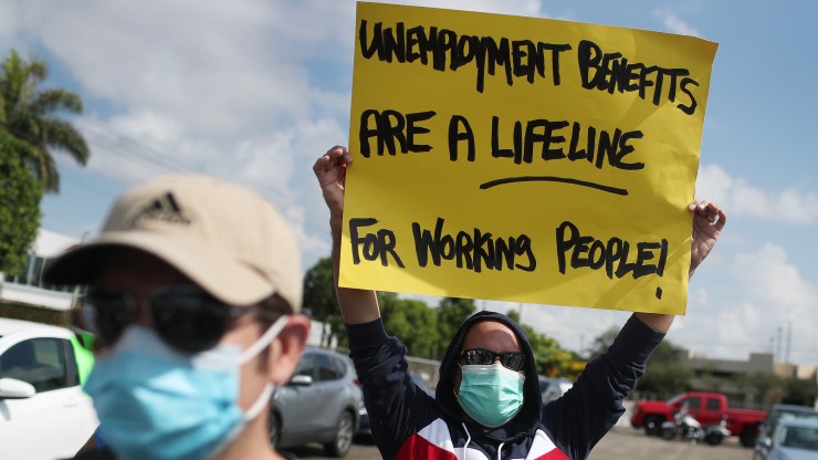 Demonstrators participate in a protest asking Senators to support the continuation of unemployment benefits in July in Miami Springs, Florida.