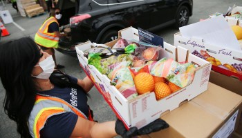 Workers from the Los Angeles Regional Food Bank distribute boxes of fresh produce to people facing food insecurity in August.