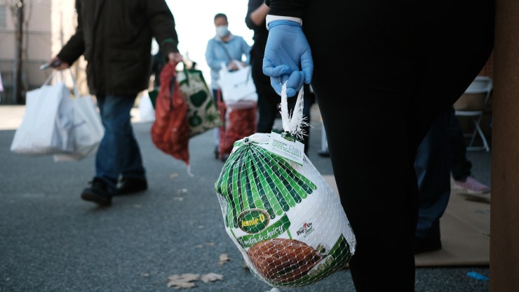People receive bags of food, including turkeys, at a Thanksgiving food distribution on Nov. 20 in New York City.