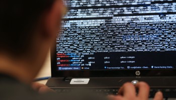 A student hacks a computer in a hacking competition in Paris.
