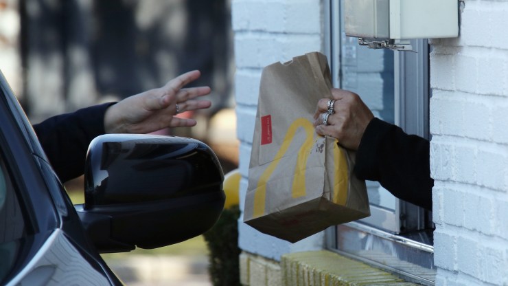 A customer at a McDonald's uses the drive-thru window in March in Hicksville, New York.