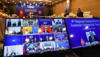 Vietnam's Prime Minister Nguyen Xuan Phuc is pictured on the screen as he addresses his counterparts during the 4th Regional Comprehensive Economic Partnership (RCEP) Summit on Nov. 15, 2020.