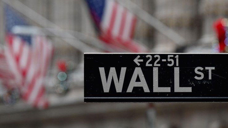 A Wall Street sign outside the New York Stock exchange (NYSE) on Nov. 30, 2020, in New York City.