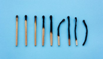 Burned matches in a row on a blue background.