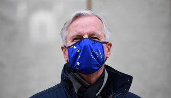 EU chief Brexit negotiator Michel Barnier, wearing an EU flag-themed face mask due to the coronavirus pandemic, leaves the conference center in London on October 28, 2020 to return to his hotel.