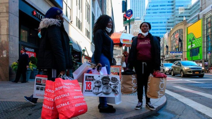 Shoppers carry bags from Macy's department store in New York on Black Friday, Nov. 27.